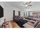A living room features leather reclining sofas, a plush black rug, and wood-look floors at 95 Shady Creek Trl, Garner, NC 27529