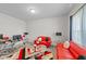 Bright living room featuring modern red sofas, unique decor, and natural light at 95 Shady Creek Trl, Garner, NC 27529