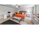 A main bedroom features a plush bed with vibrant bedding, a desk, and carpeted floors at 95 Shady Creek Trl, Garner, NC 27529