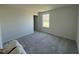 Spacious bedroom with large window and plush gray carpeting at 99 Pate Landing Dr, Selma, NC 27576
