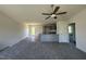 Open-concept living room showcasing new carpet, backyard access, and flow to kitchen at 99 Pate Landing Dr, Selma, NC 27576