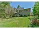 Spacious backyard with a screened-in porch and a lush lawn, surrounded by mature trees and plants at 104 Buckeye Ln, Chapel Hill, NC 27516