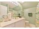 Bathroom featuring a white vanity, framed mirror and light green walls at 104 Buckeye Ln, Chapel Hill, NC 27516