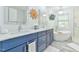 Bright bathroom with double sink vanity, soaking tub, and modern fixtures, sun decor at 104 Buckeye Ln, Chapel Hill, NC 27516