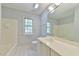 Bright bathroom featuring a tub, toilet, and large vanity with ample natural light at 104 Buckeye Ln, Chapel Hill, NC 27516