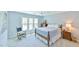 Comfortable bedroom with blue walls, large window, and ceiling fan at 104 Buckeye Ln, Chapel Hill, NC 27516