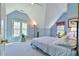 Bright bedroom with light blue walls, carpet, and plentiful natural light from two windows at 104 Buckeye Ln, Chapel Hill, NC 27516