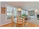 Bright dining area with hardwood floors and a view of the living area and fireplace at 104 Buckeye Ln, Chapel Hill, NC 27516