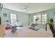 Spacious exercise room with ceiling fan, large windows, and workout equipment at 104 Buckeye Ln, Chapel Hill, NC 27516