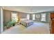 Spacious main bedroom featuring a king-size bed, three windows and neutral color scheme at 104 Buckeye Ln, Chapel Hill, NC 27516