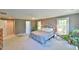 Spacious main bedroom featuring a king-size bed, two windows and neutral color scheme at 104 Buckeye Ln, Chapel Hill, NC 27516
