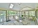 Relaxing screened-in porch with comfortable seating, a ceiling fan and skylights at 104 Buckeye Ln, Chapel Hill, NC 27516