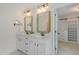 Double vanity in bathroom with modern mirrors and door that leads to walk-in closet at 104 Lowe Wood Ct, Durham, NC 27703