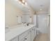 Bright bathroom with a wide white countertop, a large mirror, and tile floors at 104 Lowe Wood Ct, Durham, NC 27703