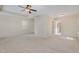 Bright, carpeted bedroom featuring ceiling fan and doorway to an attached bathroom at 104 Lowe Wood Ct, Durham, NC 27703