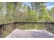 View from the brown deck to the tree-filled backyard, offering a private, peaceful outdoor space at 104 Lowe Wood Ct, Durham, NC 27703
