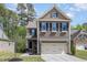 Inviting two-story home featuring a well-manicured lawn and attached two-car garage at 104 Lowe Wood Ct, Durham, NC 27703