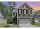 Charming two-story home with a two-car garage, dark shutters, and a well-manicured lawn at 104 Lowe Wood Ct, Durham, NC 27703