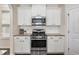 Stainless steel oven and microwave are set into the white cabinets at 104 Lowe Wood Ct, Durham, NC 27703