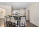 Kitchen island with barstool seating and white cabinetry at 104 Lowe Wood Ct, Durham, NC 27703
