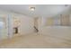 Open loft area with neutral carpet and staircase to additional rooms at 104 Lowe Wood Ct, Durham, NC 27703