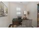 Staged home office showcasing a computer desk, patterned chair and book shelf at 104 Lowe Wood Ct, Durham, NC 27703