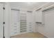 Walk-in closet with custom shelving and rods for storage, and carpet floor at 104 Lowe Wood Ct, Durham, NC 27703