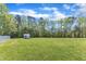 Large, green backyard with a shed at 1077 Williams-White Rd, Zebulon, NC 27597