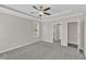 Bedroom featuring carpet, ceiling fan, and ensuite bathroom and closet access at 1077 Williams-White Rd, Zebulon, NC 27597