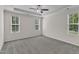 Bedroom with carpet flooring, ceiling fan, and lots of windows at 1077 Williams-White Rd, Zebulon, NC 27597