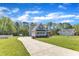 Long driveway leading to a well-maintained home with an attached garage and a spacious yard at 1077 Williams-White Rd, Zebulon, NC 27597