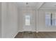 Bright entryway with a glass-paneled front door, modern lighting, and wood-look flooring at 1077 Williams-White Rd, Zebulon, NC 27597