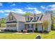 Two-story home featuring gray siding, a black roof, and a covered front porch with decorative columns at 1077 Williams-White Rd, Zebulon, NC 27597