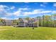 Landscaped front yard leading up to a gray two-story home, creating a welcoming curb appeal at 1077 Williams-White Rd, Zebulon, NC 27597