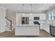 Bright kitchen with white cabinets, stainless appliances, granite countertops, and a center island at 1077 Williams-White Rd, Zebulon, NC 27597