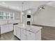 Kitchen island with granite counters and pendant lights, open to fireplace in living room at 1077 Williams-White Rd, Zebulon, NC 27597