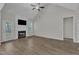 Spacious living room features hardwood floors, a fireplace, and a ceiling fan at 1077 Williams-White Rd, Zebulon, NC 27597