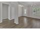 Open-concept living area with wood flooring, large windows, and modern light fixtures at 1077 Williams-White Rd, Zebulon, NC 27597