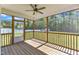 Relaxing screened-in porch with ceiling fan and wood flooring at 1077 Williams-White Rd, Zebulon, NC 27597