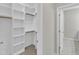 Organized walk-in closet with ample shelving and wood rods at 1077 Williams-White Rd, Zebulon, NC 27597