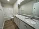 Bathroom features a double vanity, white cabinets, granite counters, and wood-look flooring at 108 Pate Landing Dr, Selma, NC 27576