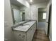 Bathroom featuring a double vanity, granite counters, and wood-look flooring at 108 Pate Landing Dr, Selma, NC 27576