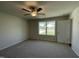 This bedroom features neutral paint, a ceiling fan, large window, and plush carpeting at 108 Pate Landing Dr, Selma, NC 27576