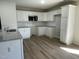 Well-lit kitchen boasts modern appliances, white cabinetry, subway tile backsplash, and ample counter space at 108 Pate Landing Dr, Selma, NC 27576