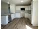 Modern kitchen showcases granite countertops, white cabinets, a stainless steel microwave, and wood-look flooring at 108 Pate Landing Dr, Selma, NC 27576