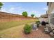 Spacious backyard with a wooden fence, a well-maintained lawn, and patio furniture at 1103 Kudzu St, Durham, NC 27713
