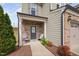 Inviting front entrance with brick accents and covered porch with seating at 1103 Kudzu St, Durham, NC 27713
