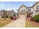 Charming townhouse with a brick facade, two-car garage, and professionally landscaped front yard at 1103 Kudzu St, Durham, NC 27713