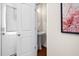 Compact powder room showcases a pedestal sink, hardwood floors, and framed artwork at 1103 Kudzu St, Durham, NC 27713