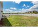 Spacious backyard with a white fence, concrete patio, and outdoor seating, ideal for entertaining at 1110 Bent Willow Dr, Durham, NC 27704